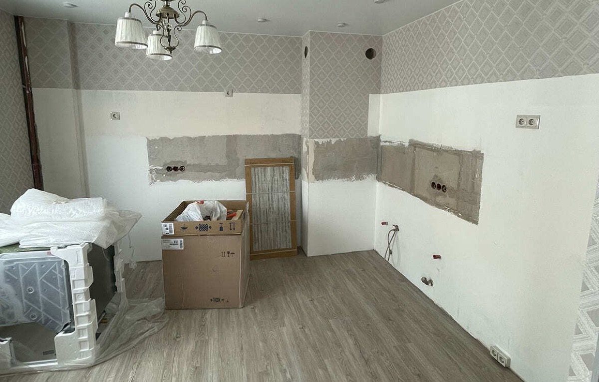 Комната после демонтажа старой кухни: коробки, голые стены